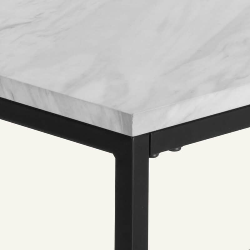 Close-up of marble effect rectangular coffee table with black metal frame.
