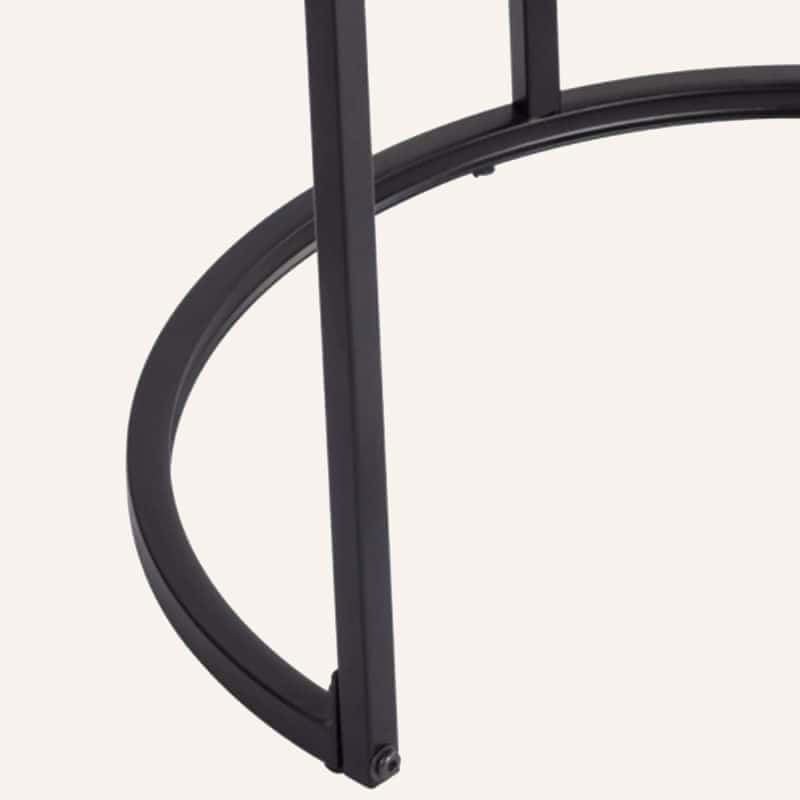 Close-up of a black metal nesting coffee table with curved design.