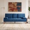 Mid-Century Blue Velvet Sofa Elegant blue velvet sofa in modern living room with artwork.