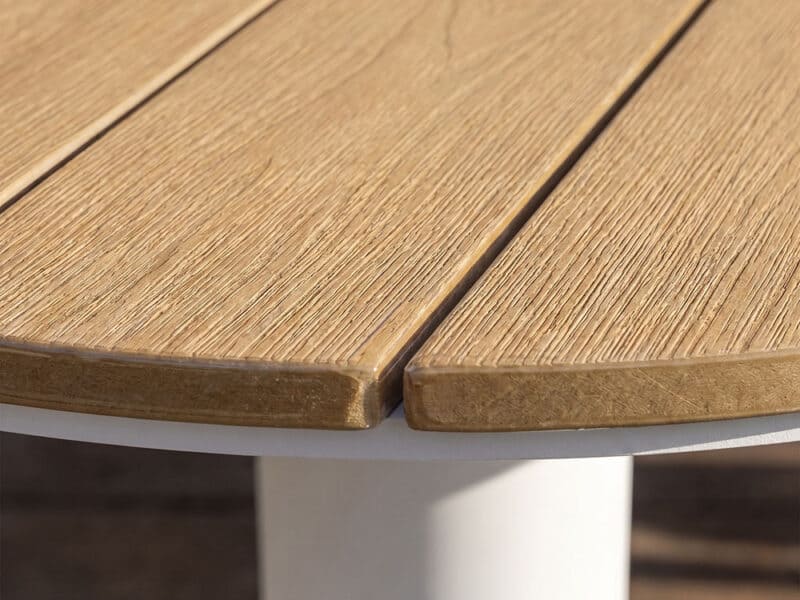OTF-566-1 Close-up of a Harbourline slatted outdoor table's wooden surface and white leg.