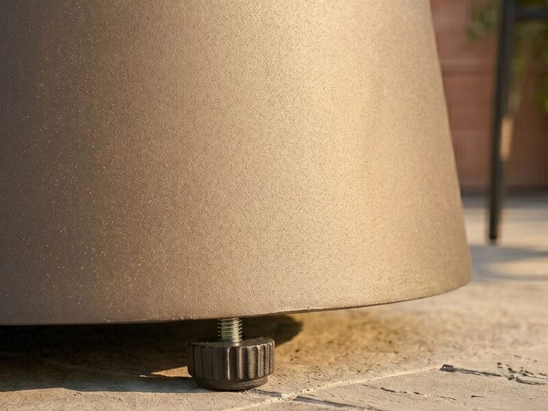 OTF-565-2 Close-up of a beige outdoor table leg on a tiled surface.