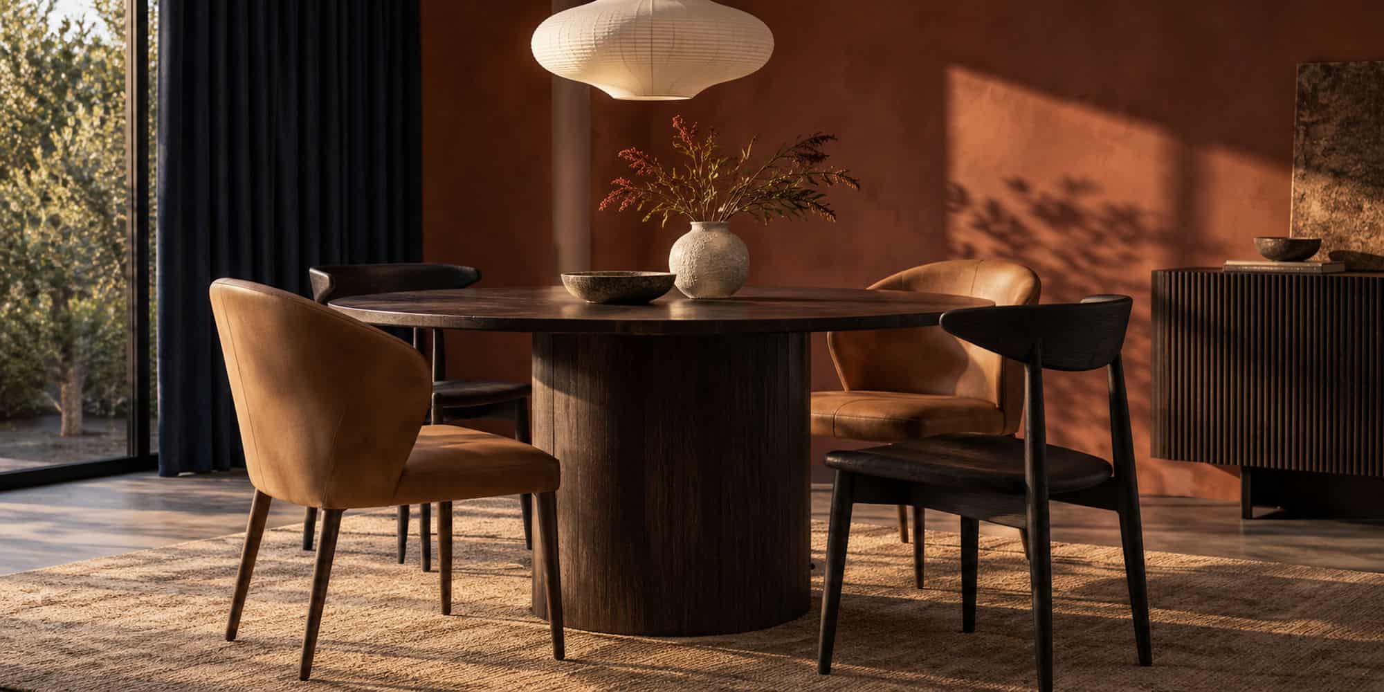 Elegant dining room with stylish chairs and warm lighting at Dreamo Living.