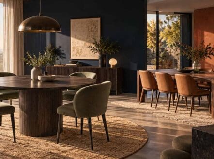 Elegant dining room with large windows and stylish furniture.